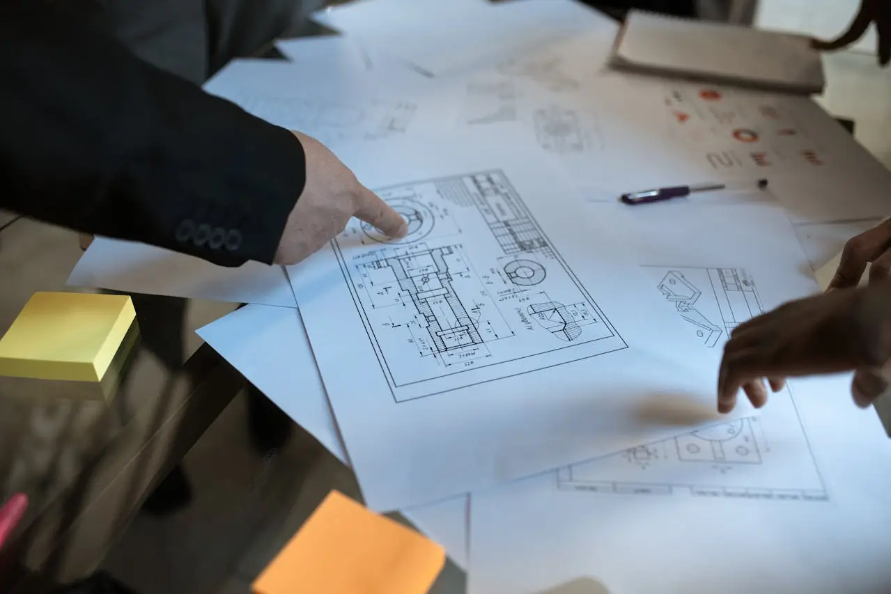 Quantity Surveyors Christchurch reviewing construction blueprints on a table